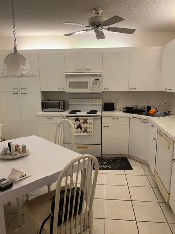 a kitchen with a stove a sink and a refrigerator