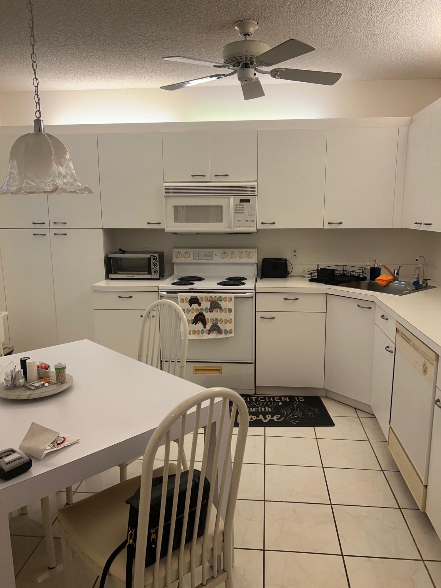 5265 Brisata Circle, Unit E Boynton Beach, FL 33437 - Photo 7 of 30 a kitchen with a stove a sink and a refrigerator