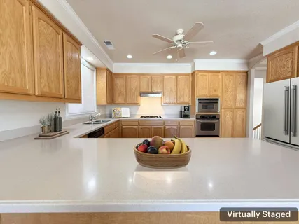 a kitchen with a sink appliances and cabinets