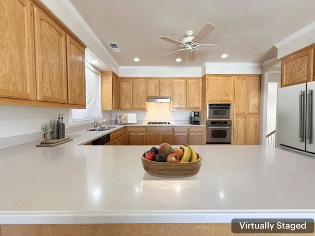 a kitchen with a sink appliances and cabinets