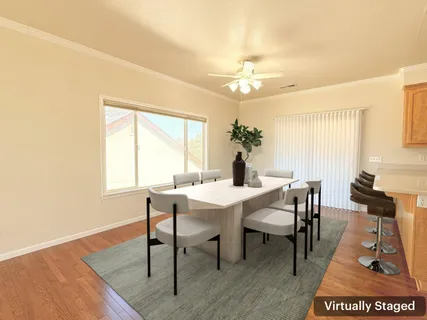 a view of a dining room with furniture and wooden floor