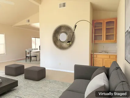 a living room with furniture and a mirror