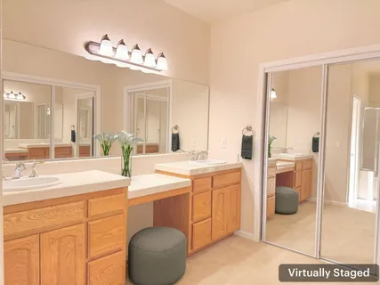 a spacious bathroom with a sink a mirror and a shower