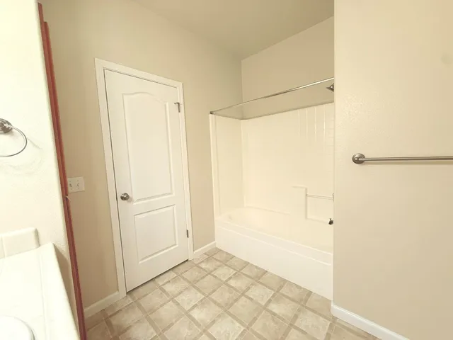a bathroom with a bathtub and a shower