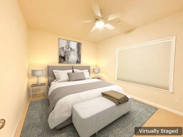 a bedroom with a bed and a painting on the wall