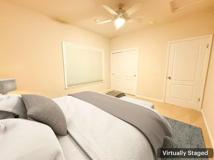 a bedroom with a large bed and a chandelier