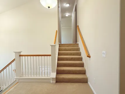 a view of staircase with white walls