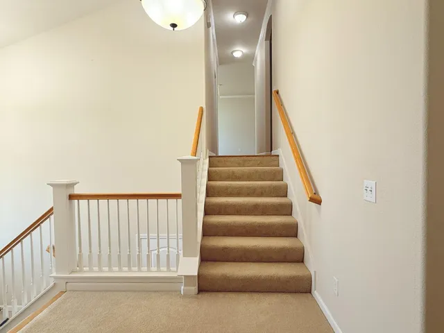 a view of staircase with white walls