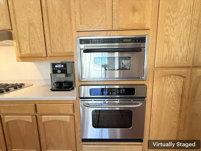 a kitchen with granite countertop cabinets stainless steel appliances and a counter space