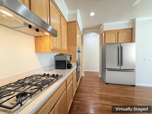a kitchen with stainless steel appliances a stove a sink and a refrigerator