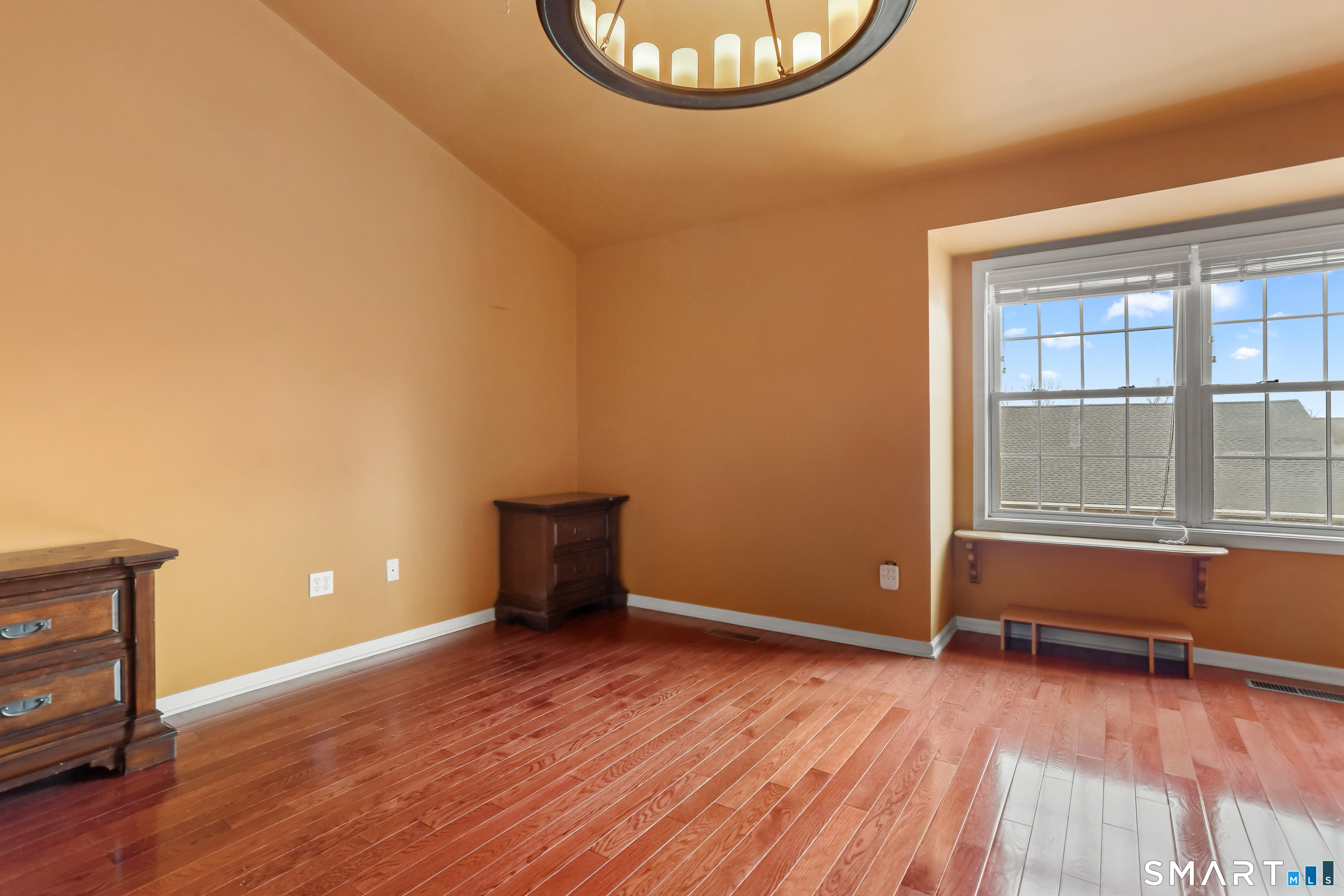 39 Coram Road, Unit 1 Shelton, CT 06484 - Photo 20 of 28 an empty room with wooden floor and windows