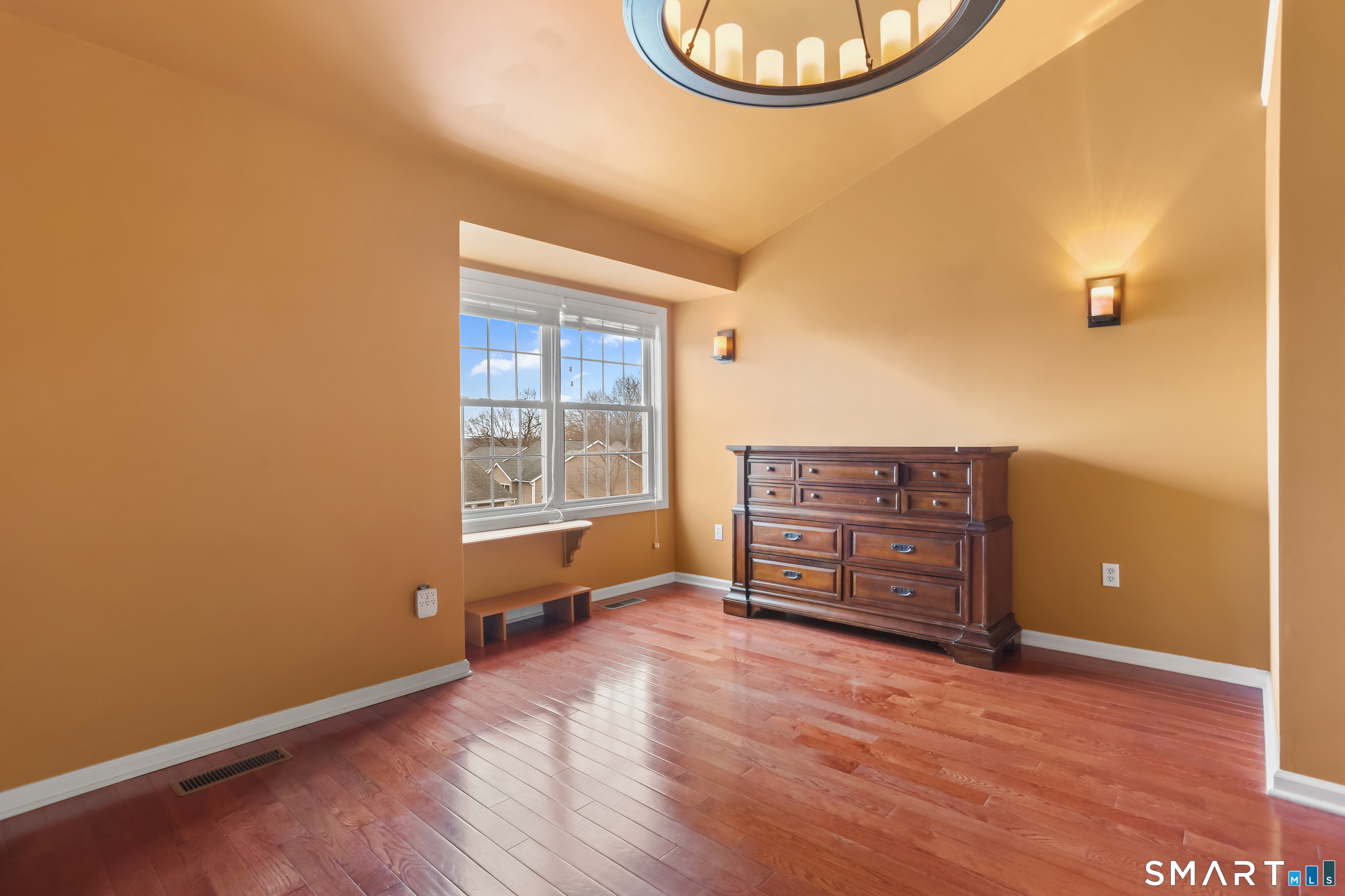 39 Coram Road, Unit 1 Shelton, CT 06484 - Photo 21 of 28 an empty room with cabinet and wooden floor