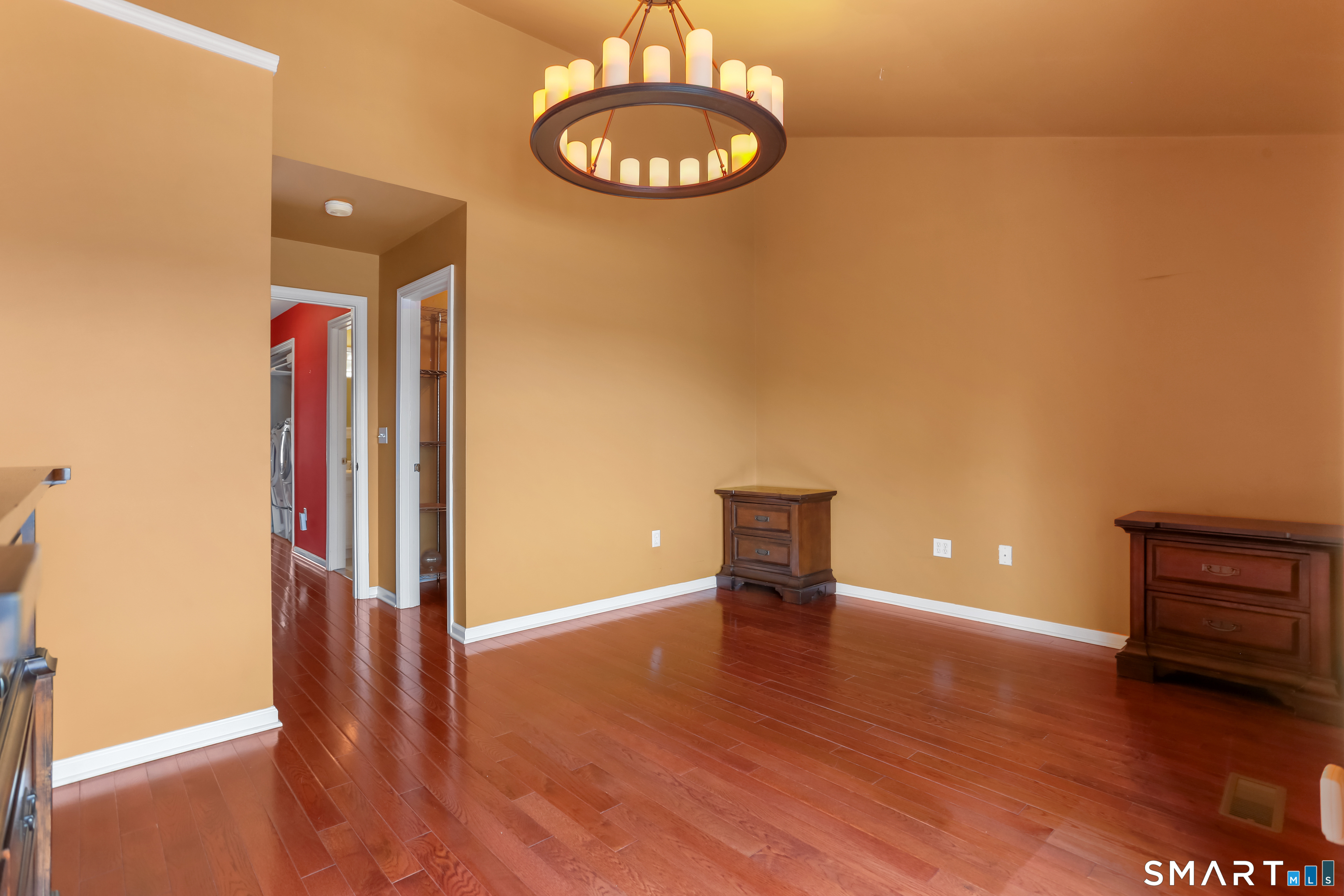 39 Coram Road, Unit 1 Shelton, CT 06484 - Photo 22 of 28 an empty room with wooden floor and mirror