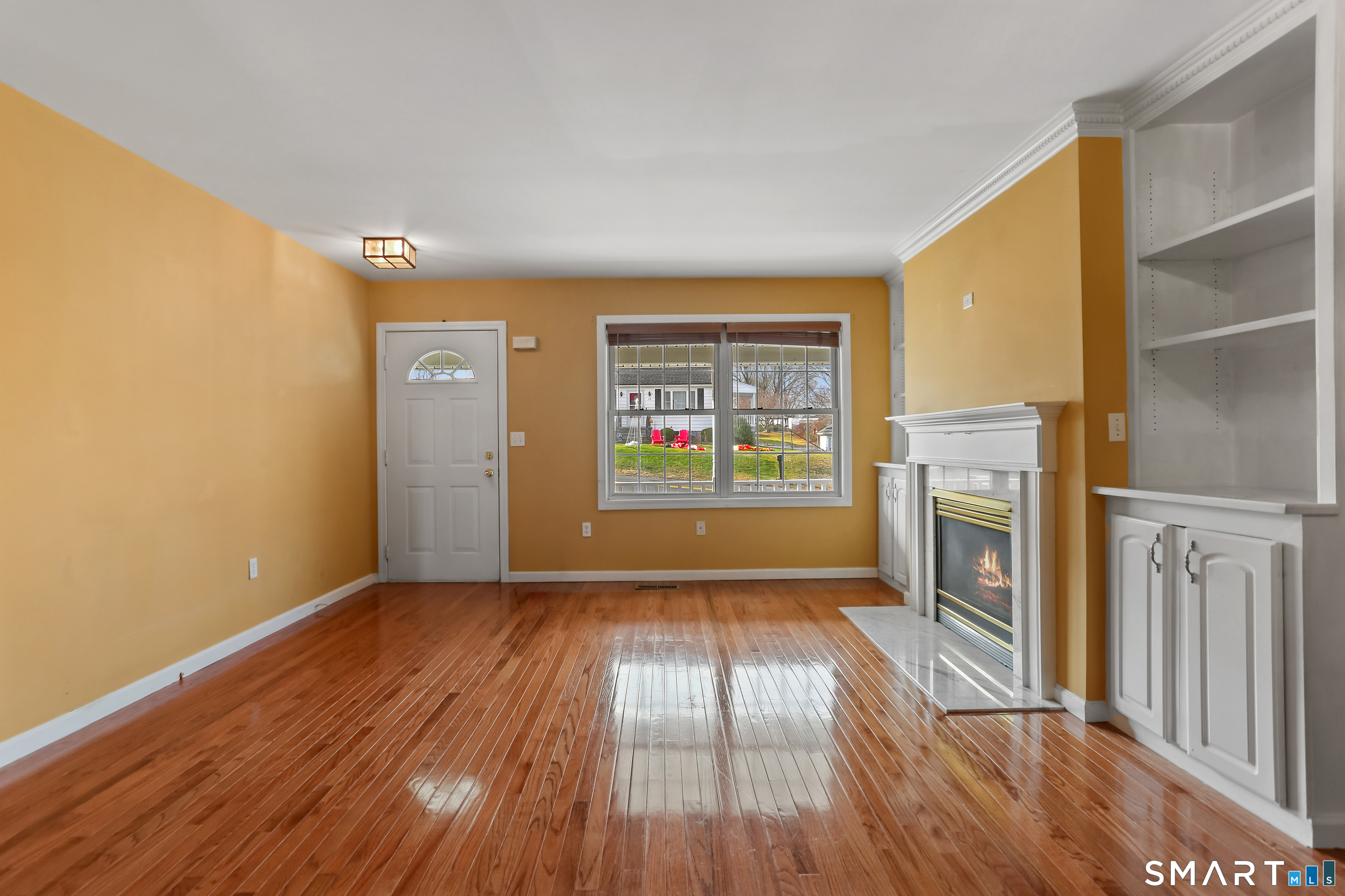 39 Coram Road, Unit 1 Shelton, CT 06484 - Photo 4 of 28 a view of an empty room with a fireplace and a window