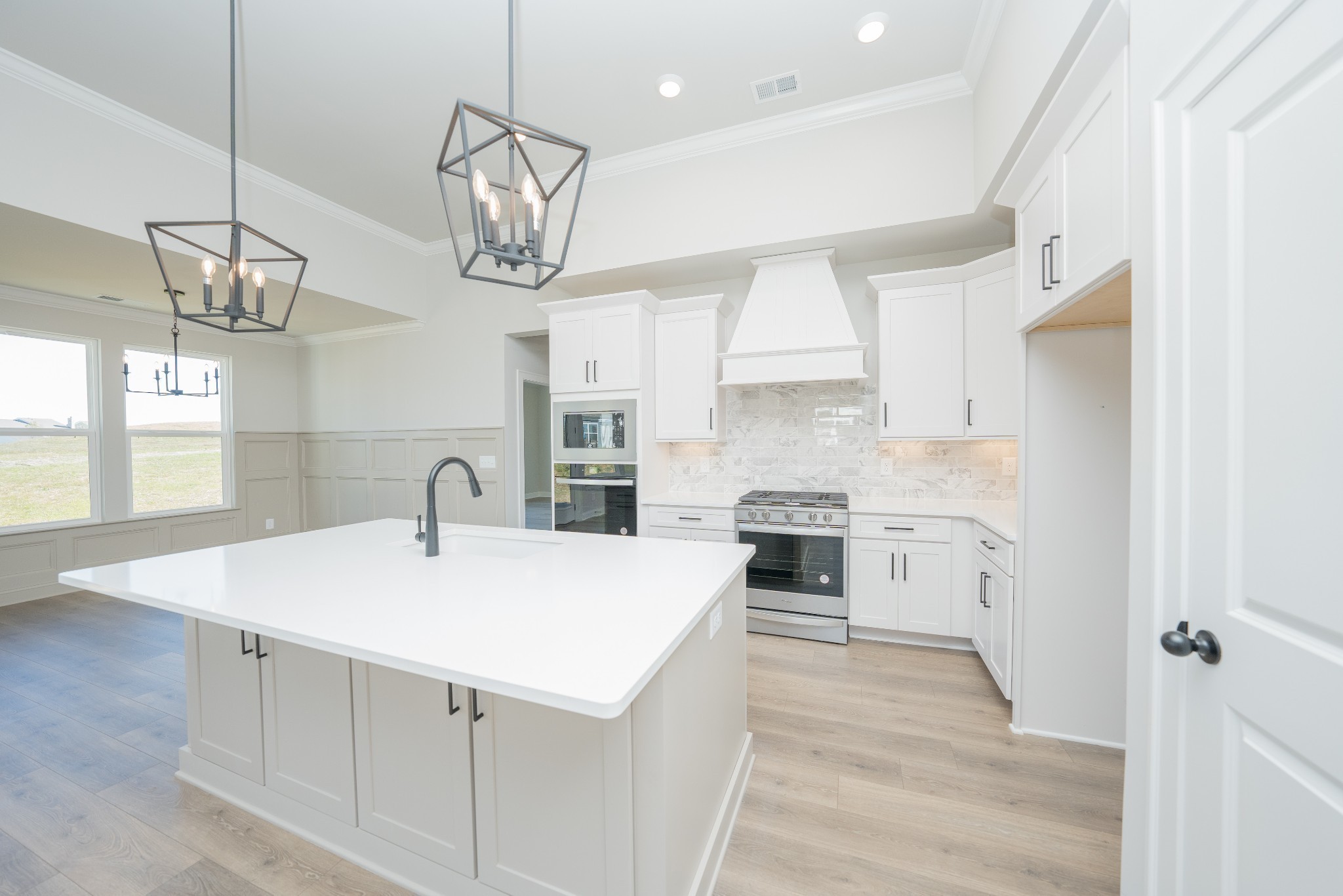3033 Shandor St Spring Hill Spring Hill, TN 37174 - Photo 17 of 70 a kitchen with a sink a chandelier stainless steel appliances cabinets and a window