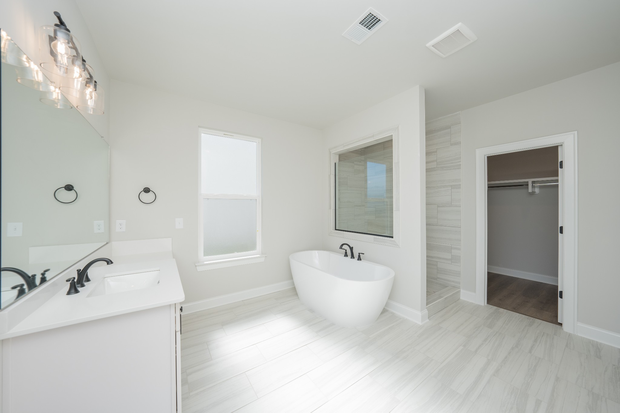 3033 Shandor St Spring Hill Spring Hill, TN 37174 - Photo 31 of 70 a spacious bathroom with a bathtub sink and mirror