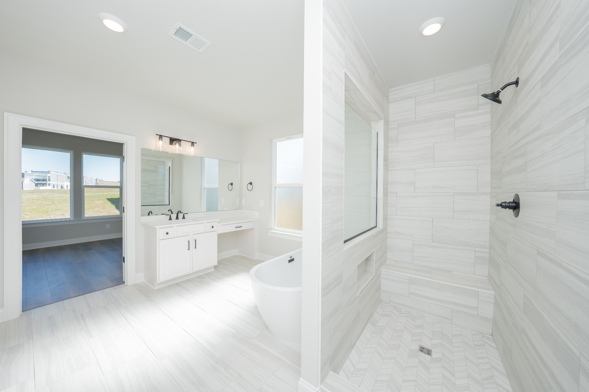 3033 Shandor St Spring Hill Spring Hill, TN 37174 - Photo 32 of 70 a bathroom with a glass door shower a sink and a mirror