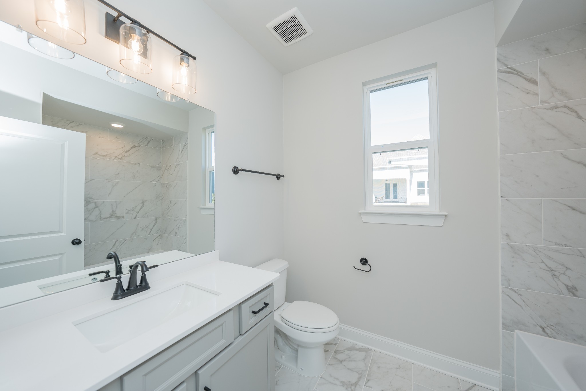 3033 Shandor St Spring Hill Spring Hill, TN 37174 - Photo 45 of 70 a bathroom with a sink a toilet and mirror