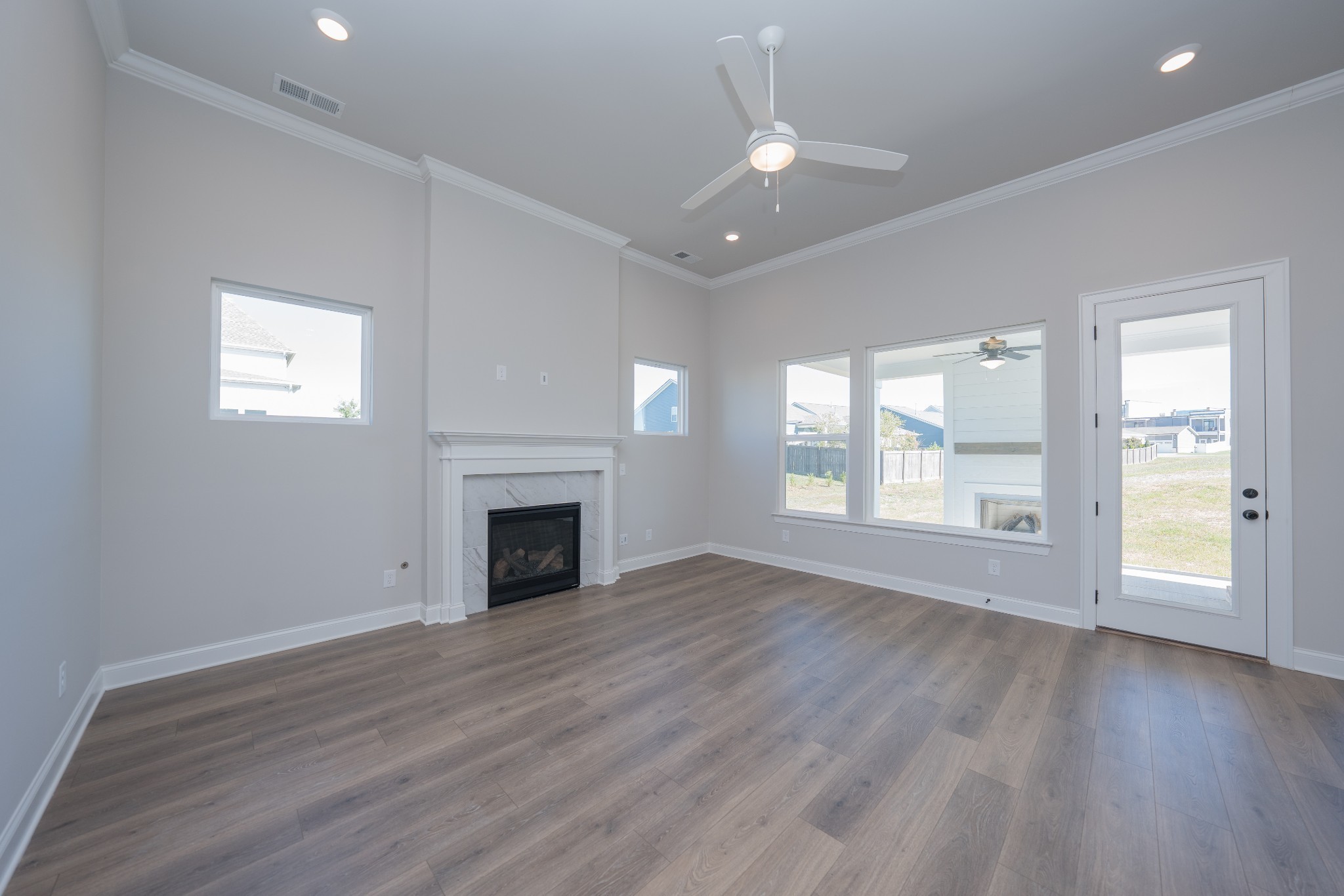 3033 Shandor St Spring Hill Spring Hill, TN 37174 - Photo 9 of 70 an empty room with wooden floor fireplace and windows
