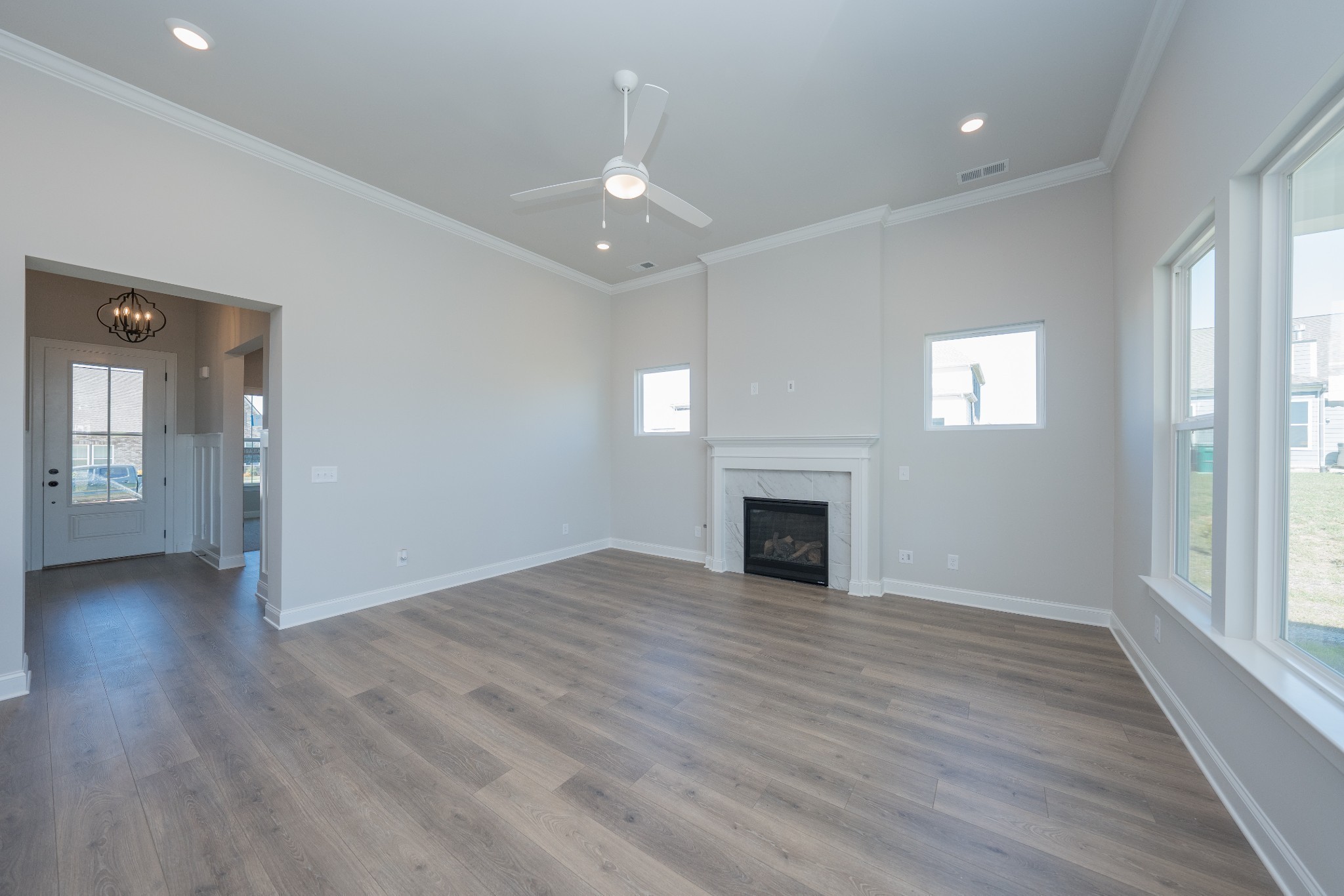 3033 Shandor St Spring Hill Spring Hill, TN 37174 - Photo 10 of 70 an empty room with wooden floor fireplace and windows