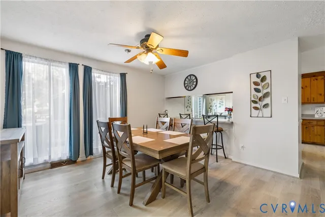 a view of a dining room with furniture and a large window