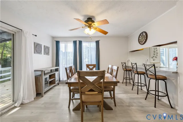 a view of a dining room with furniture and a chandelier