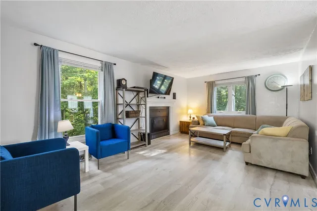 a living room with furniture and a fireplace