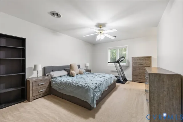 a bedroom with a bed dresser and a window