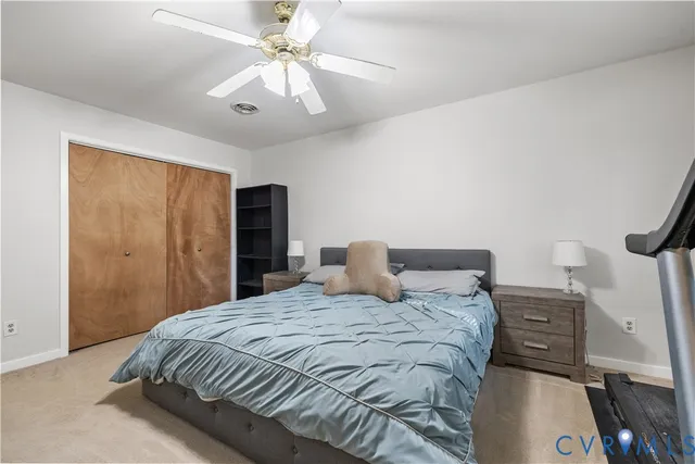 a bedroom with a bed a chandelier and closet