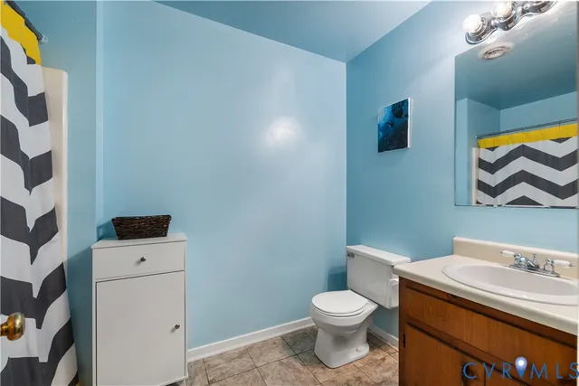 a bathroom with a sink toilet and mirror