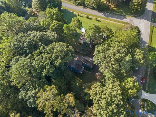 an aerial view of a house with a yard
