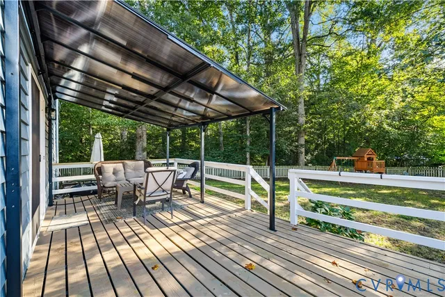 a view of balcony with chairs and wooden fence