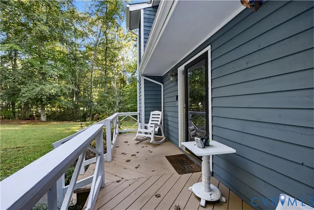 a view of balcony with wooden floor and fence