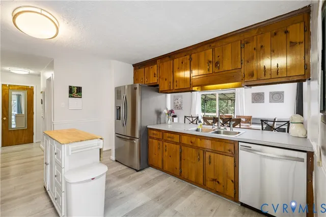 a kitchen with a sink cabinets and stainless steel appliances