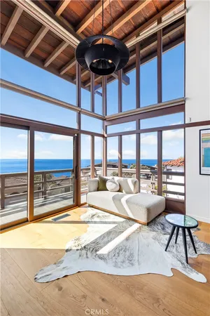 a living room with furniture and a floor to ceiling window