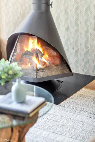 a living room with furniture and a floor to ceiling window