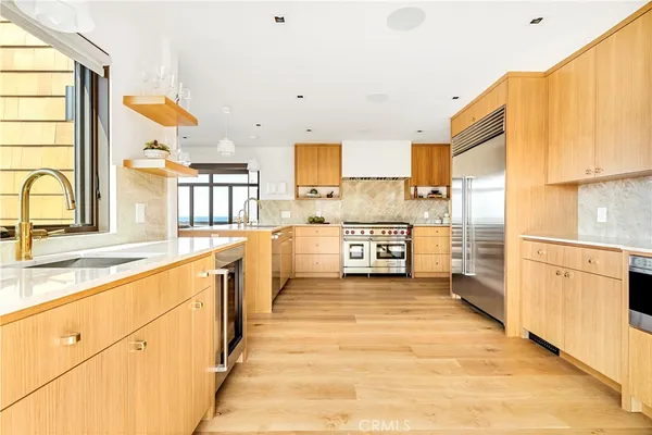 a large white kitchen with a large window