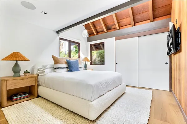 a bedroom with a bed and a large window