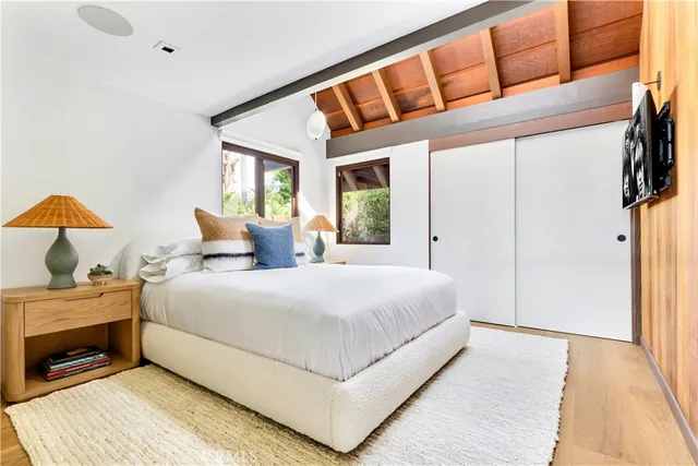 a bedroom with a bed and a large window