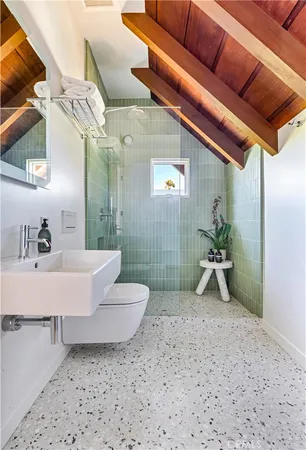a bathroom with a double vanity sink toilet and a mirror