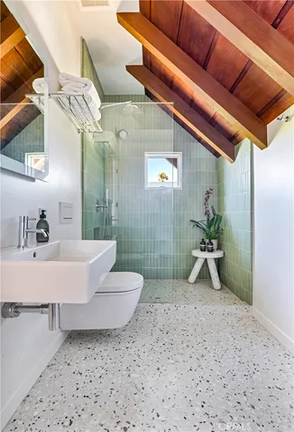 a bathroom with a double vanity sink toilet and a mirror