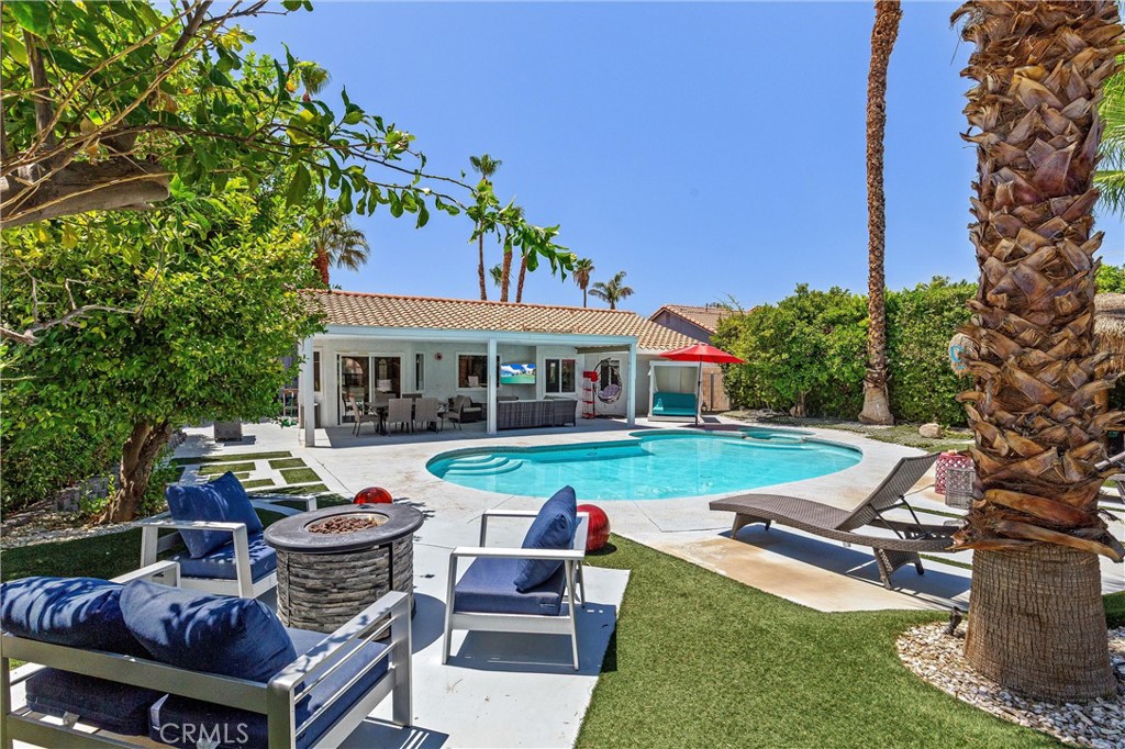 68190 Galardo Road Cathedral City, CA 92234 - Photo 19 of 24 a view of a house with backyard sitting area and swimming pool