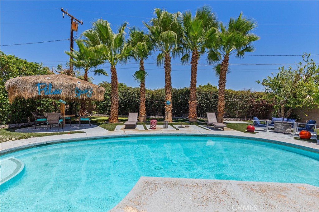 68190 Galardo Road Cathedral City, CA 92234 - Photo 23 of 24 a view of a swimming pool with lawn chairs under an umbrella