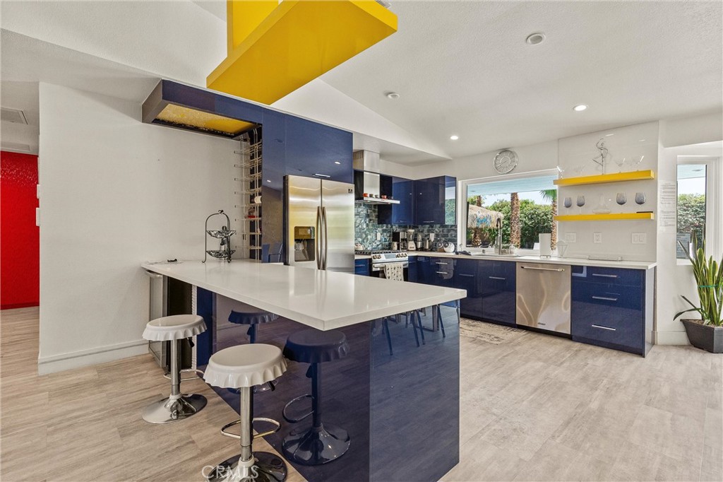 68190 Galardo Road Cathedral City, CA 92234 - Photo 7 of 24 a kitchen with a sink a counter top space stainless steel appliances and cabinets