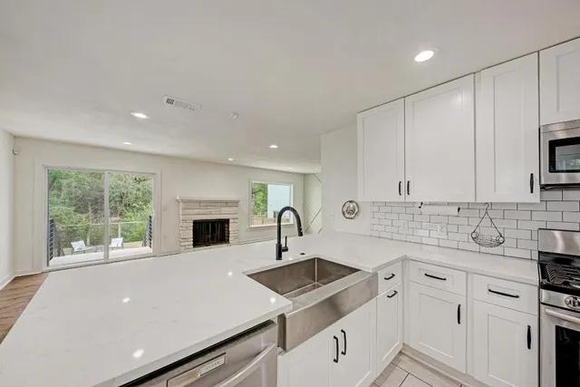 a kitchen with sink cabinets and window