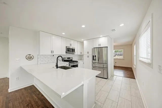 a kitchen with refrigerator and microwave