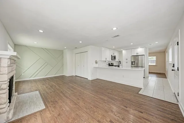 a view of kitchen with kitchen island white cabinets and refrigerator