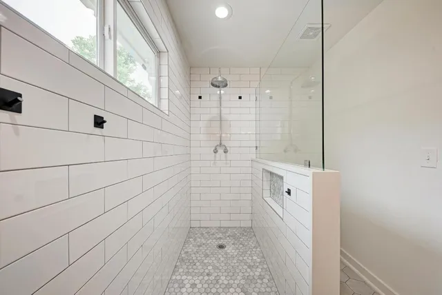 a bathroom with a bathtub and shower