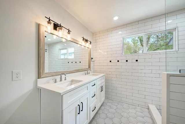a bathroom with a double vanity sink mirror and double