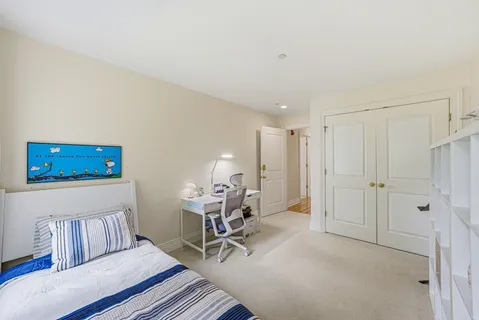 a view of a bedroom with furniture and windows